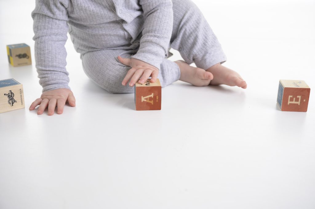 Baby hands and feet with wooden blocks. 