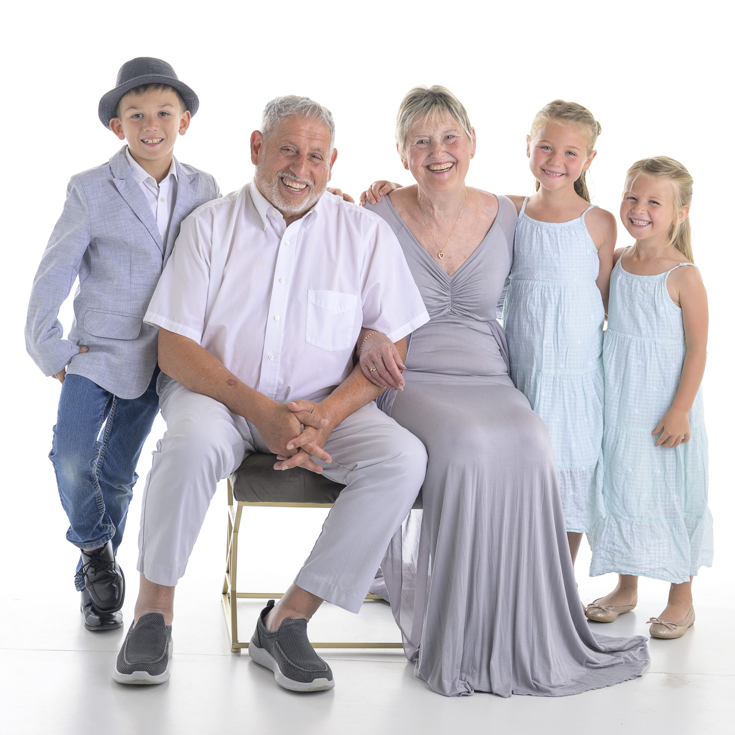 Grandchildren and Grandparent portrait on white in a photography studio