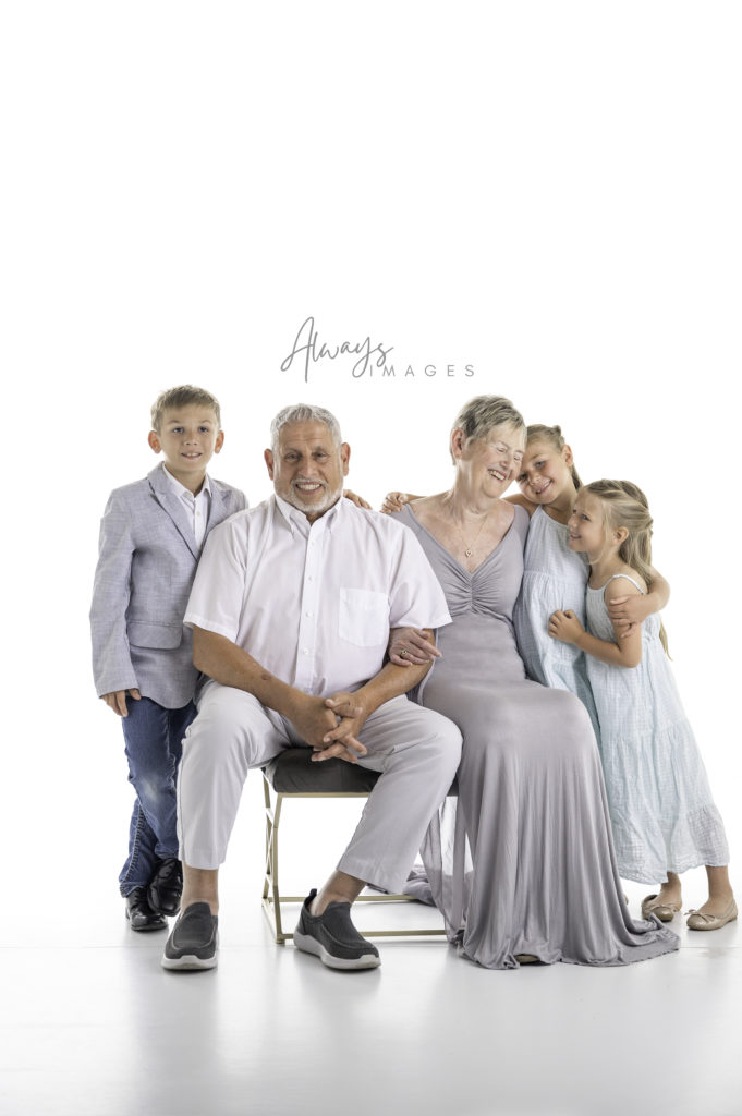 Grandparents with grandchildren on white background. 