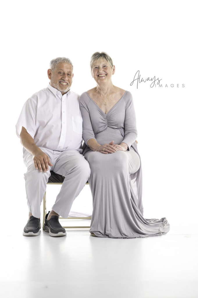 Older couple portrait on white background. 