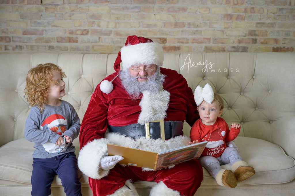 Santa reading a story to small children in the Always Images photography studio.