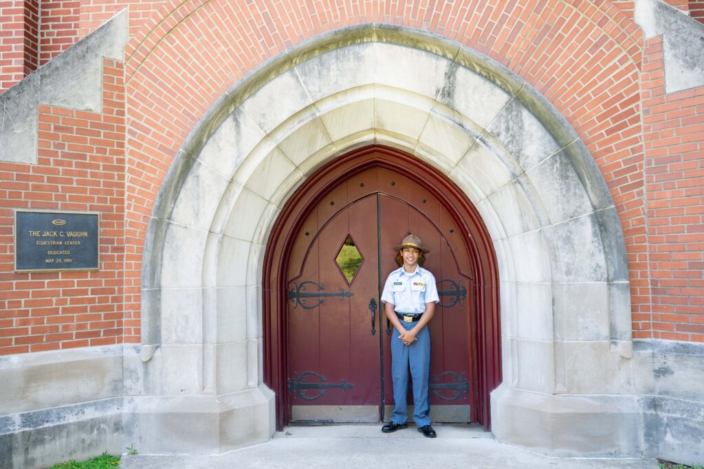Troop formal portrait outside doors to Vaughn Equestrian Center. 