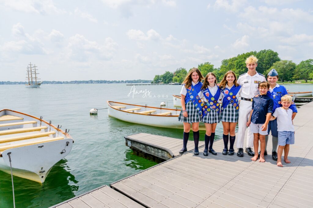 Woodcraft and Upper Campers with siblings on pier with the Ledbetter and Lake Maxinkuckee in the background. 